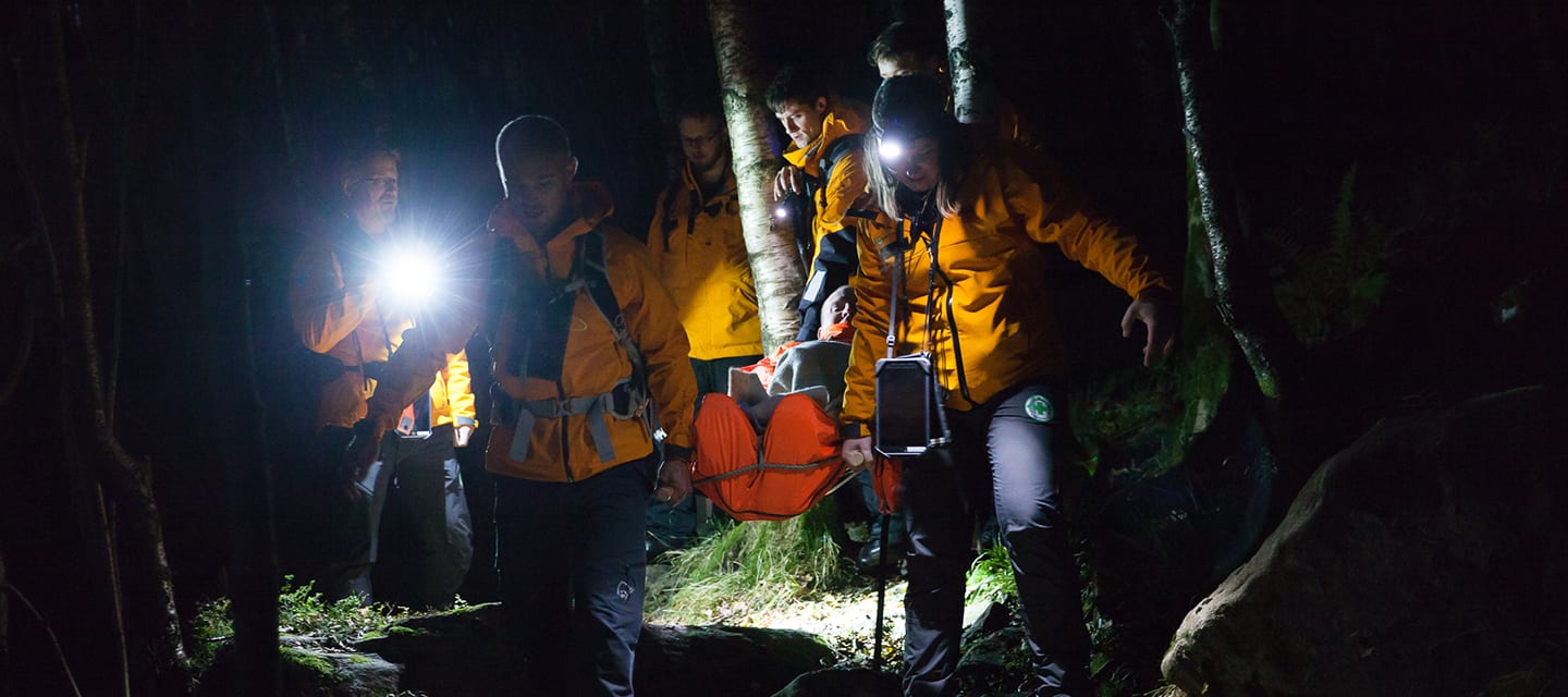 Workers from Norsk Folkehjelp helping a person at night time