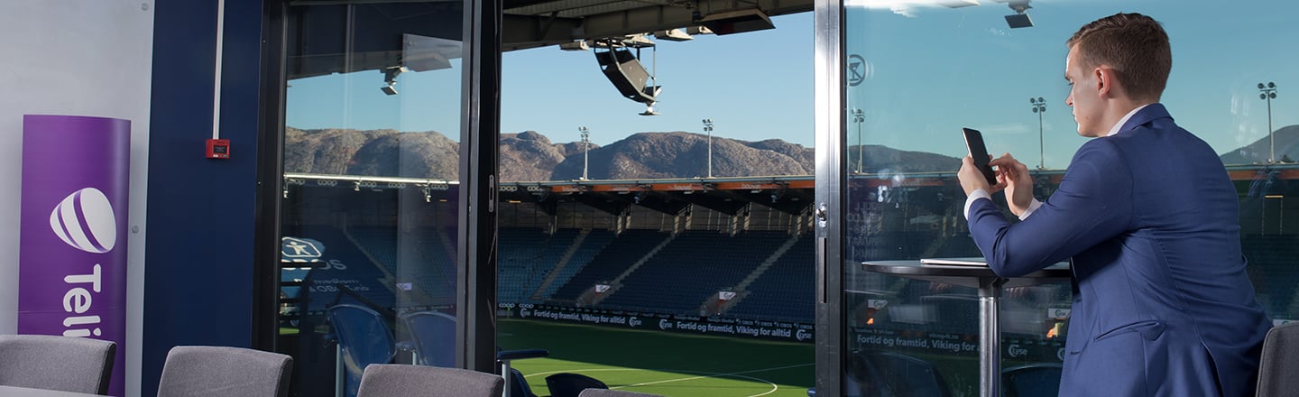 Mann bruker telefon i VIP-losje på SR-Bank Arena i Stavanger