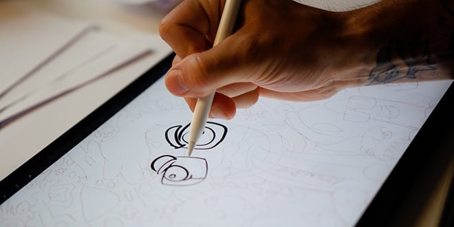 Christopher Robin Omdahl is sketching away at the drawing board.